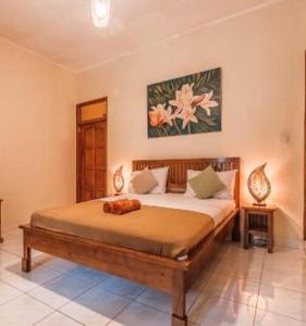 a bedroom with a large bed in a room at Kaia Lovina Guest House in Lovina