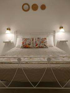 a large bed with two pillows on top of it at Oltre la Vite in Selva di Fasano +15 photos
