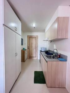 a small kitchen with a sink and a door at Lengs Place 1 - Studio Unit at Inspiria Condo Beside Abreeza Mall Davao City in Davao City