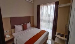 Tempat tidur dalam kamar di Sparks Odeon Sukabumi, ARTOTEL Curated