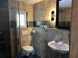 a bathroom with a sink and a toilet at Maier Pension in Bayerisch Eisenstein