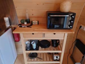 a tiny kitchen with a microwave on top of a counter at Hobbit Hut in Hallstahammar