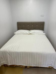 Postel nebo postele na pokoji v ubytování Hotel Uptown Semenyih