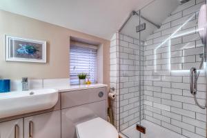 uma casa de banho com um WC, um lavatório e um chuveiro em The Station Loft City Centre 1-Bed Apartment em Worcester