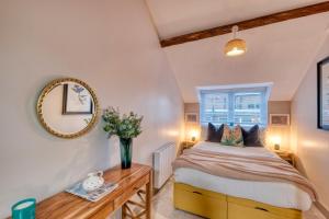 a bedroom with a bed and a mirror at The Station Loft City Centre 1-Bed Apartment in Worcester