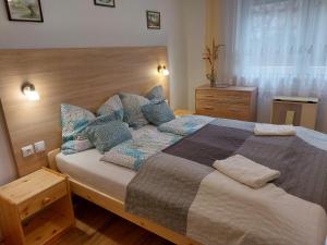 a bedroom with a large bed with blue pillows at Budaiapertment in Budapest