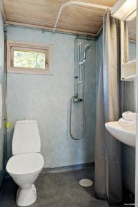 a bathroom with a toilet and a shower and a sink at First Camp Tylösand-Halmstad in Tylösand