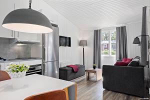 a kitchen and living room with a table and chairs at First Camp Tylösand-Halmstad in Tylösand