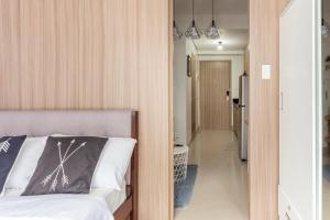a bedroom with a bed and a hallway at Shore 2 Apartment with Balcony in Manila