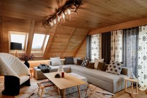 a living room with a couch and a table at Vila Pavlina in Kranjska Gora
