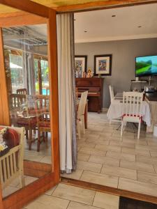 a living room with a view of a dining room at 3 Brothers B&B in Edenvale