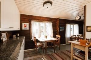 a kitchen and dining room with a table and chairs at Guesthouse Torppa in Korkeakoski