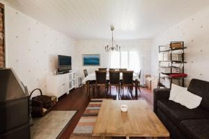 a living room with a couch and a table at Guesthouse Torppa in Korkeakoski