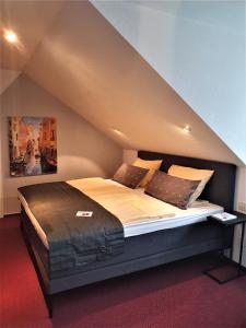 ein Schlafzimmer mit einem großen Bett im Dachgeschoss in der Unterkunft Hotel Neuenfels in Badenweiler