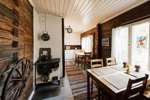 a dining room with a table and a stove at Guesthouse Torppa in Korkeakoski
