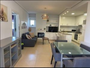 a kitchen and living room with a couch and a table at Playa Flamenca 151 in Playa Flamenca