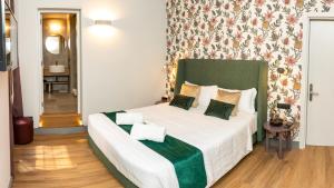 a bedroom with a large bed with a green headboard at Castel Sant Angelo Luxury Rooms and Tour in Rome