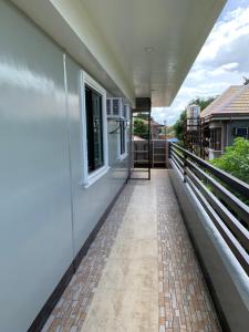 a balcony of a house with a walkway at Suncrest Inn in Butuan