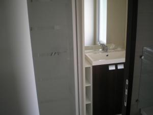 a bathroom with a shower and a sink and a mirror at Camping des Cigales in Aiguèze