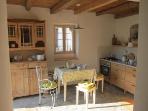 a kitchen with a table and chairs in a room at Flori Adriatic in Marezige