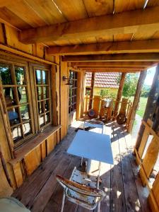 an inside view of a cabin with a table and chairs at Cabane insolite TOUT CONFORT Chalet Gites Luzy Morvan Bourgogne in Luzy