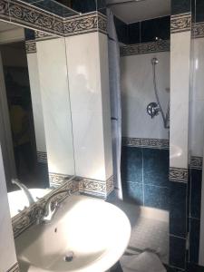 a bathroom with a sink and a shower at Alloggio Turistico Roberta San Pietro in Rome