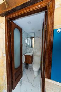 a bathroom with a toilet and a sink at Valletta Old Well Apartments in Valletta