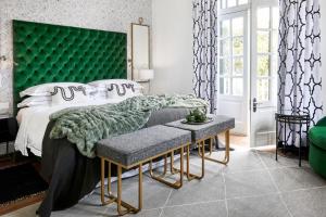 a bedroom with a green headboard and a bed at Cape Cadogan Boutique Hotel in Cape Town