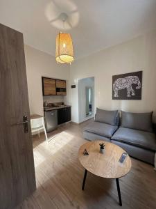 a living room with a couch and a table at Elefsinian Mysteries Apartments in Eleusis
