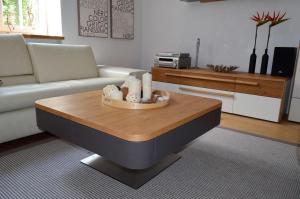 a living room with a couch and a coffee table at Hello Apartments Modena Sw Ducha in Gdańsk