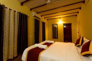 a bedroom with a bed with towels on it at The Mayflower - Heritage Villa in Alleppey