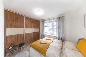 een slaapkamer met een bed en een raam bij Tower Apartments in Spišská Nová Ves