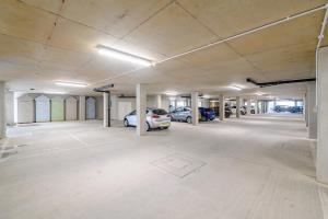 an empty parking garage with cars parked in it at 11 Woolacombe West - Luxury Apartment at Byron Woolacombe, only 4 minute walk to Woolacombe Beach! in Woolacombe