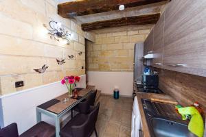 a small kitchen with a table and a stove at Valletta Traditional Townhouse in Valletta