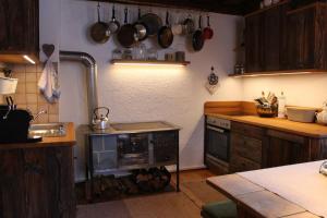 a kitchen with a stove and a counter with pots and pans at Droneberger-Hütte in Schwarzenbach