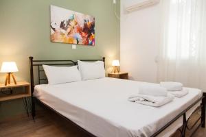 a bedroom with a bed with white towels on it at Beautiful new apartment in Petralona in Athens