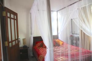 A bed or beds in a room at Mango Tree House