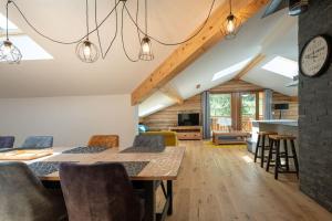 a dining room and living room with a table and chairs at Les 3 Sophies - Magnifique chalet pour 1 à 8 personnes proche des remontées mécaniques des prodains in Morzine