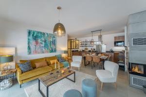 a living room with a couch and a dining room at Alpujarra - Apt 304 - BO Immobilier - Châtel - remises sur les forfaits de skis Châtel ou Portes du soleil in Châtel