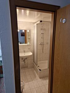 a bathroom with a shower and a sink at Gasthof Post in Mittersill