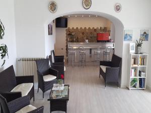 a waiting room with chairs and a counter with a bar at Hotel Bellavista Ischia in Ischia