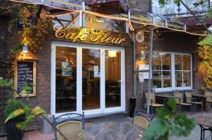 a cafe sign on the front of a restaurant at City Hotel in Geilenkirchen