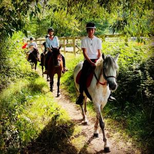 a group of people riding horses down a trail at Domaine La Fontaine B&B in Soubran