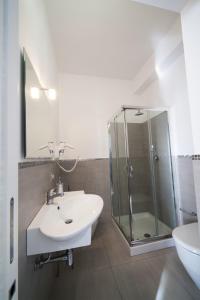 a bathroom with a sink and a glass shower at B&b Diamond in San Vito lo Capo +20 photos
