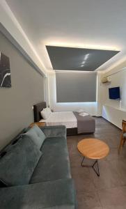 a living room with a couch and a bed at Acropolis View Apartment Athens Downtown in Athens