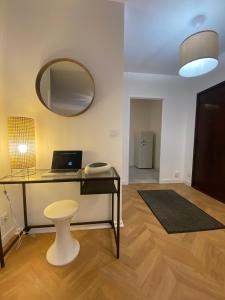 a room with a desk with a laptop and a mirror at Spacieux logement au pied du Vercors in Saint-Jean-en-Royans