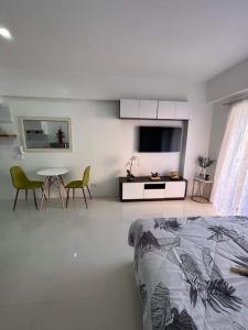 a bedroom with a bed and a table and chairs at 88Minesview LODGE By SUNTRUST CONDOMINIUM in Baguio
