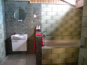 a bathroom with a sink and a tub and a toilet at Pokoje Gościnne Liv Marina in Ustka