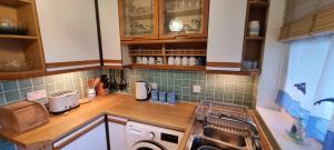 a kitchen with a sink and a stove top oven at 9 Wheal Ramoth, Atlantic bay in Perranporth