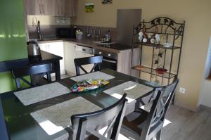 a kitchen with a dining room table and chairs at Gite Du Petit Coteau in Vouvray